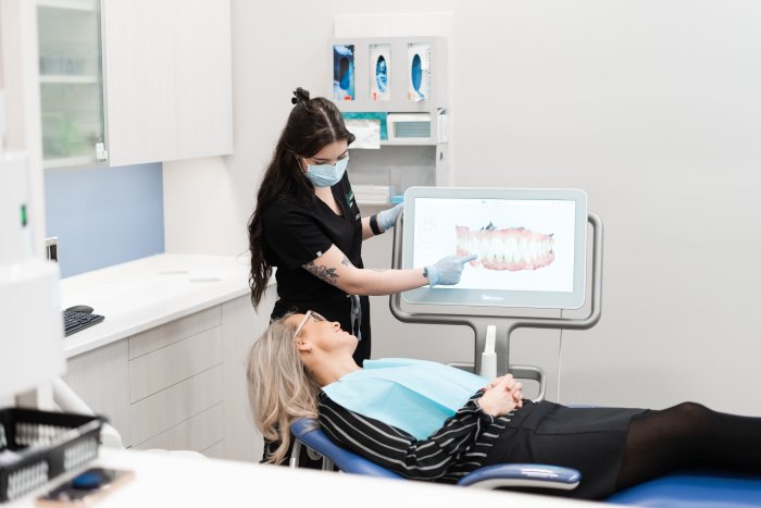 A patient looks at a 3D scan of their teeth.