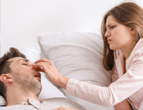 A woman pinches her partners nose to stop him from snoring in Victoria