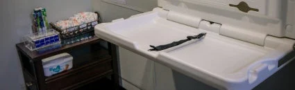 A baby change table with diapers and wipes, inside the family washroom at Parkway Dental in Langford.