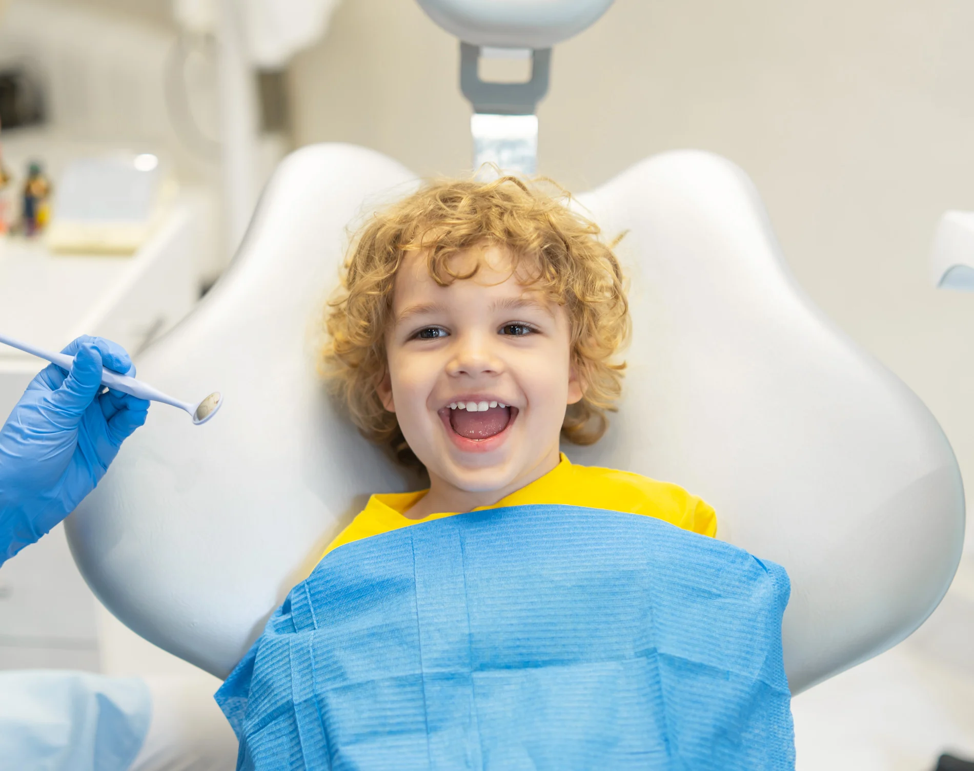 A young boy at Parkway Dental gets his teeth checked by the dentist just before laser dentistry