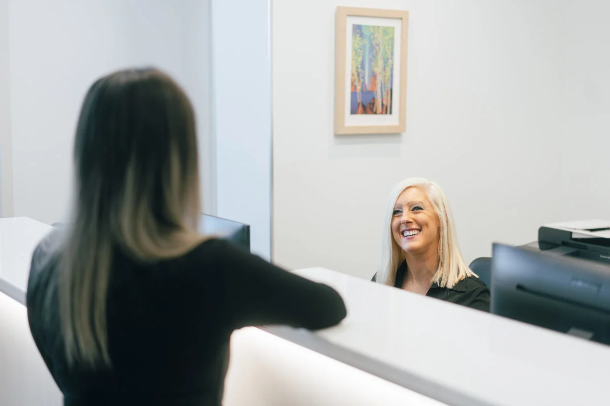 A patient is warmly greeted at the Parkway Dental upper floor reception.