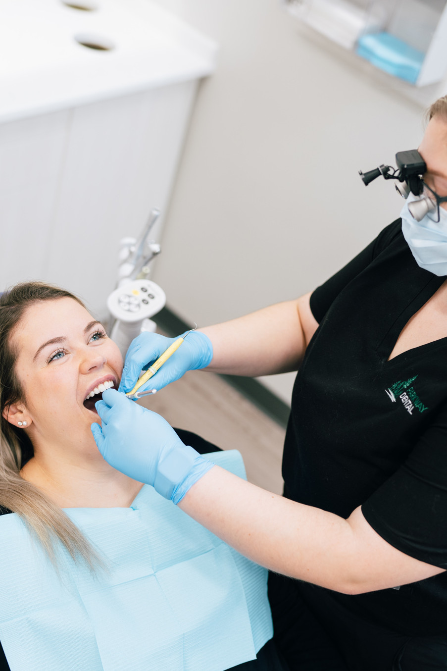 A new patient exam teeth cleaning is performed by a Parkway Dental hygienist.